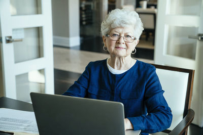 Portrait of senior woman using laptop computer at home