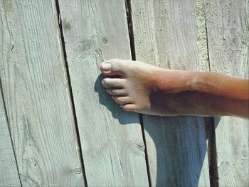 Close-up of hands on wood