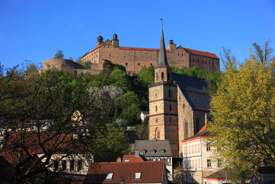 Low angle view of buildings against blue sky