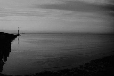 Scenic view of sea against sky at dusk