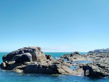 Scenic view of sea against clear blue sky