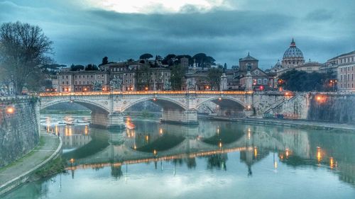 Bridge over river with buildings in background