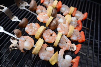 Close-up of shrimps skewers on barbecue grill