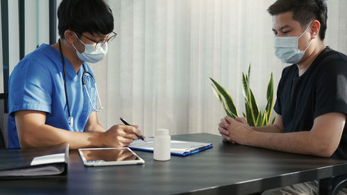 Female friends working at table