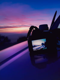 Close-up of silhouette car against sky during sunset