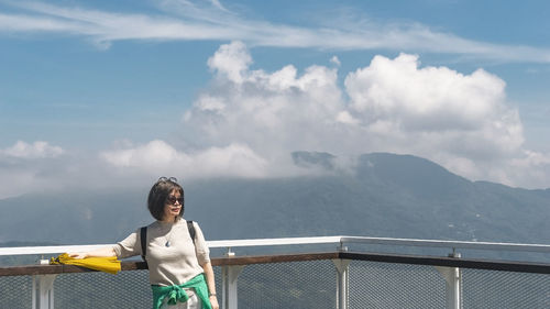 Rear view of woman standing against mountain