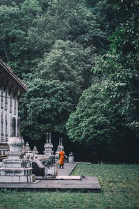 View of buddha statue against trees and building