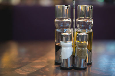 Close-up of condiment shakers on table