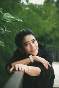 Portrait of young woman sitting on field