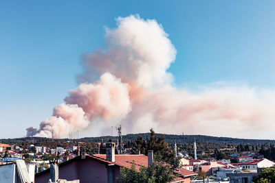 Smoke emitting from chimney against sky