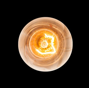 Directly above shot of coffee cup against black background