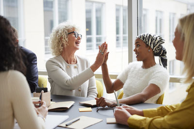 Businesswomen high fiving in office