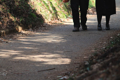 Low section of people walking on footpath