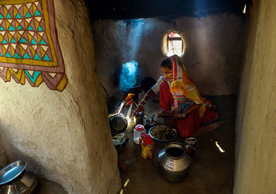 High angle view of woman sitting by building