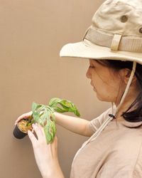 Midsection of woman holding ice cream against wall