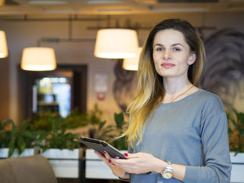 Portrait of young woman using mobile phone