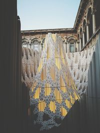 Low angle view of clothes hanging on window