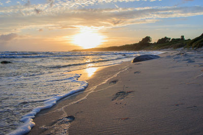 Scenic view of beach against sky during sunset