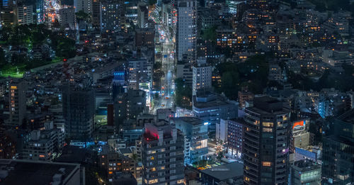 High angle view of illuminated buildings in city at night
