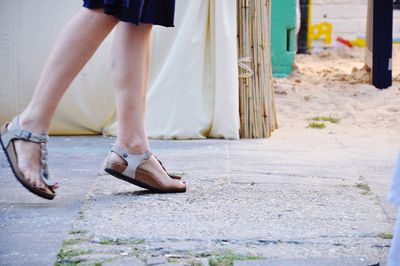 Low section of woman standing on tiled floor