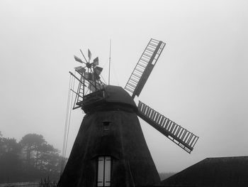 Low angle view of traditional windmill against sky