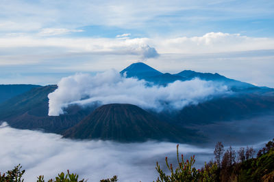 Scenic view of mountains against cloudy sky