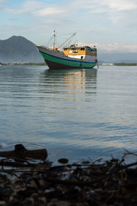 Fishing boats in sea against sky