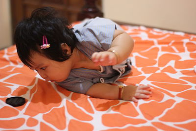 Girl sitting on bed at home