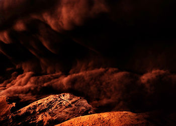 Rock formation against sky at night