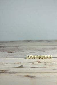 Close-up of text on wooden table