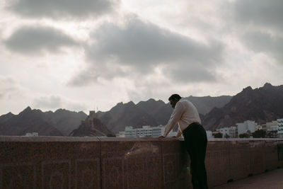 Man standing on mountain against sky