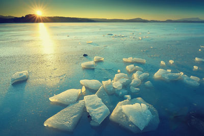 Water and ice edge. ice with brilliant color covered dark water in bay. blue ice on freezing lake