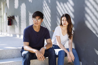 Young couple sitting in city