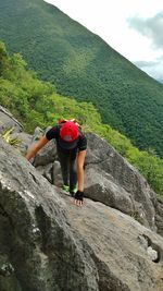 Full length of woman standing on cliff