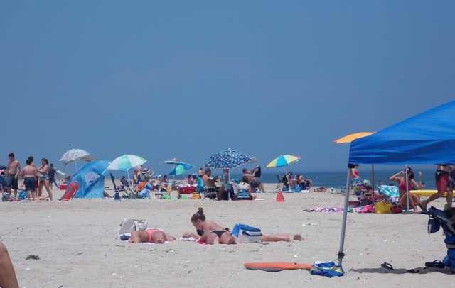 beach, sand, large group of people, sea, clear sky, vacations, shore, leisure activity, relaxation, water, beach umbrella, copy space, lifestyles, men, person, blue, summer, parasol, horizon over water