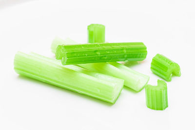 Close-up of green chili pepper against white background