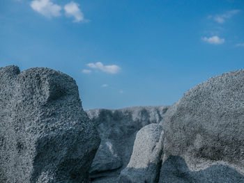 Low angle view of rock formations against sky