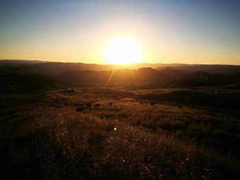 Scenic view of landscape against sky during sunset