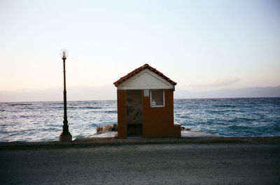 Built structure on beach against clear sky