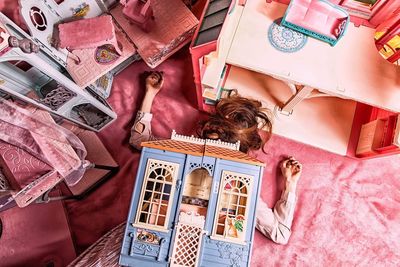 High angle view of woman under dollhouse