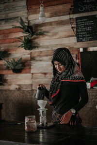 Woman holding coffee cup