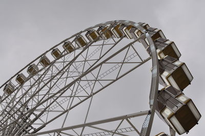 Low angle view of ferris wheel against sky