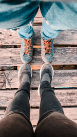 Low section of people standing on boardwalk