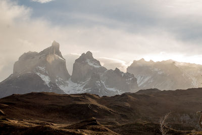 Scenic view of mountains against cloudy sky