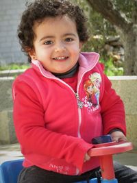 Portrait of smiling girl sitting in park