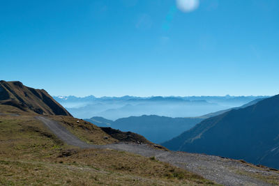 Scenic view of mountains against clear blue sky