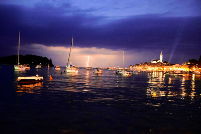 Sailboats in sea at night