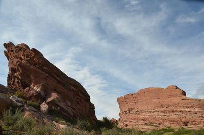 Low angle view of rocky mountains against sky