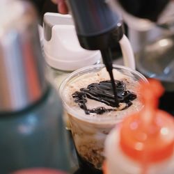 Close-up of coffee pouring in glass