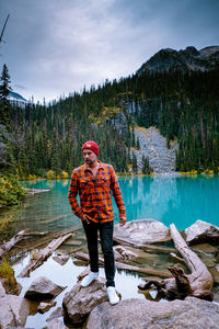 Man standing by lake against mountain